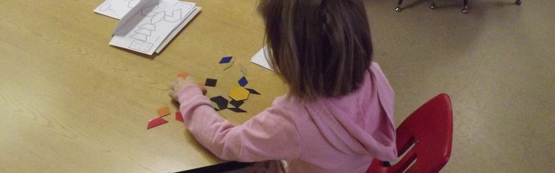Children working together on a large floor puzzle