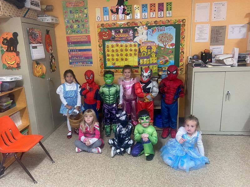 Children dressed in Halloween costumes in the classroom