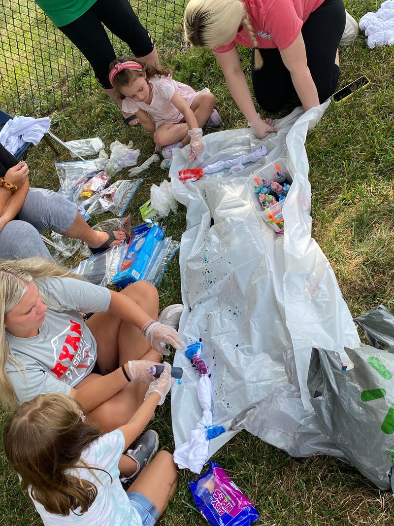 Children working on an outdoor art project on the grass